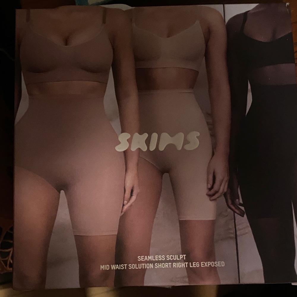 SKIMS Seamless Sculpt Mid Waist Shorts right leg exposed- bronze